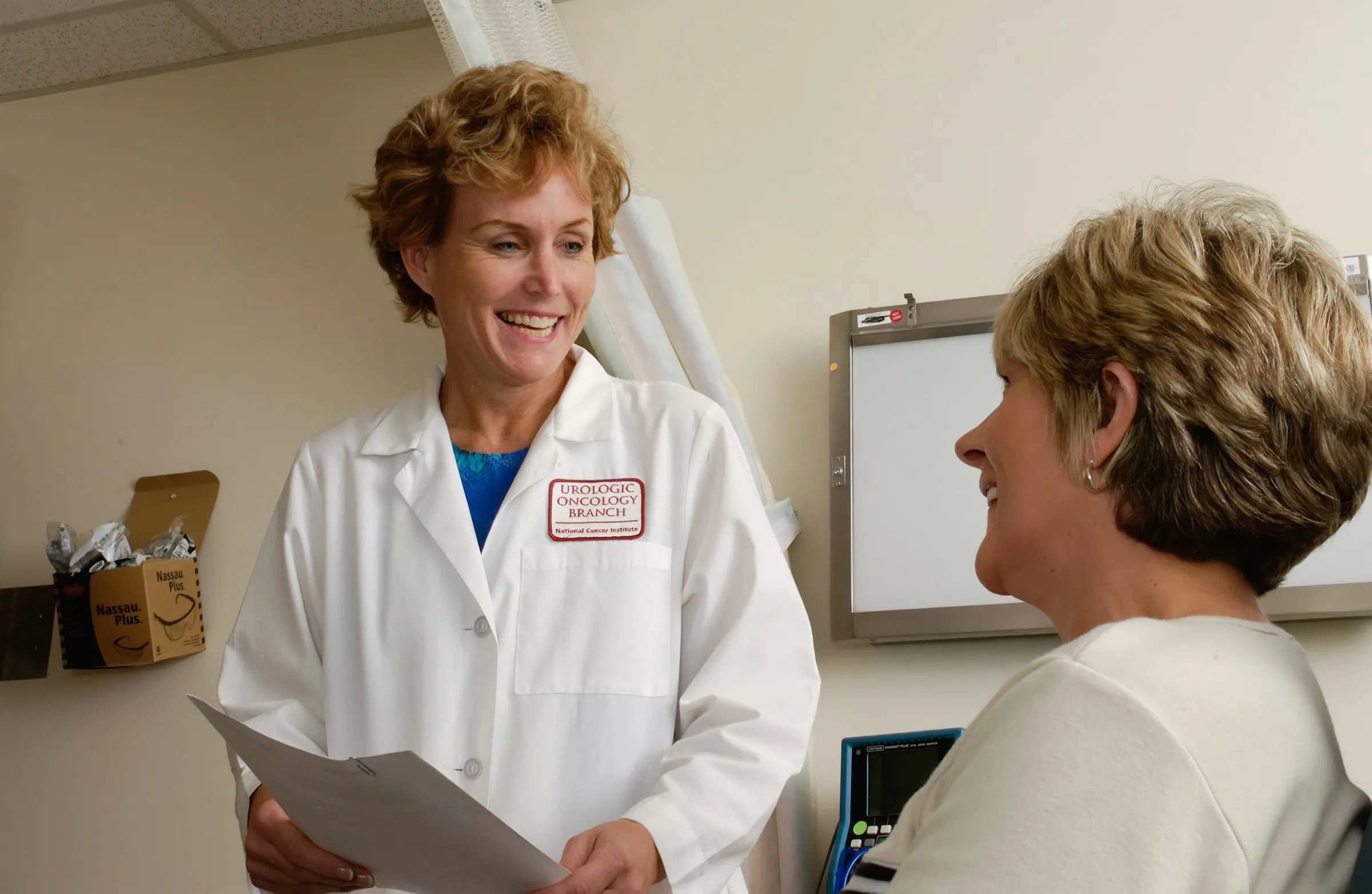 Smiling doctor talking with a patient