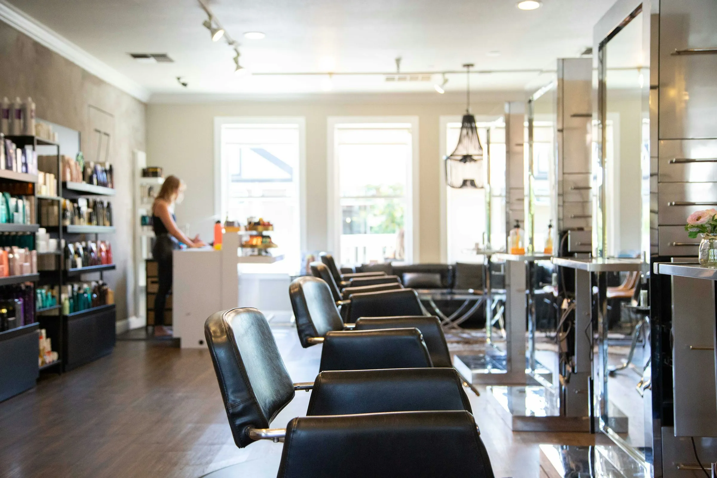 Bright salon with a reception desk and styling chairs