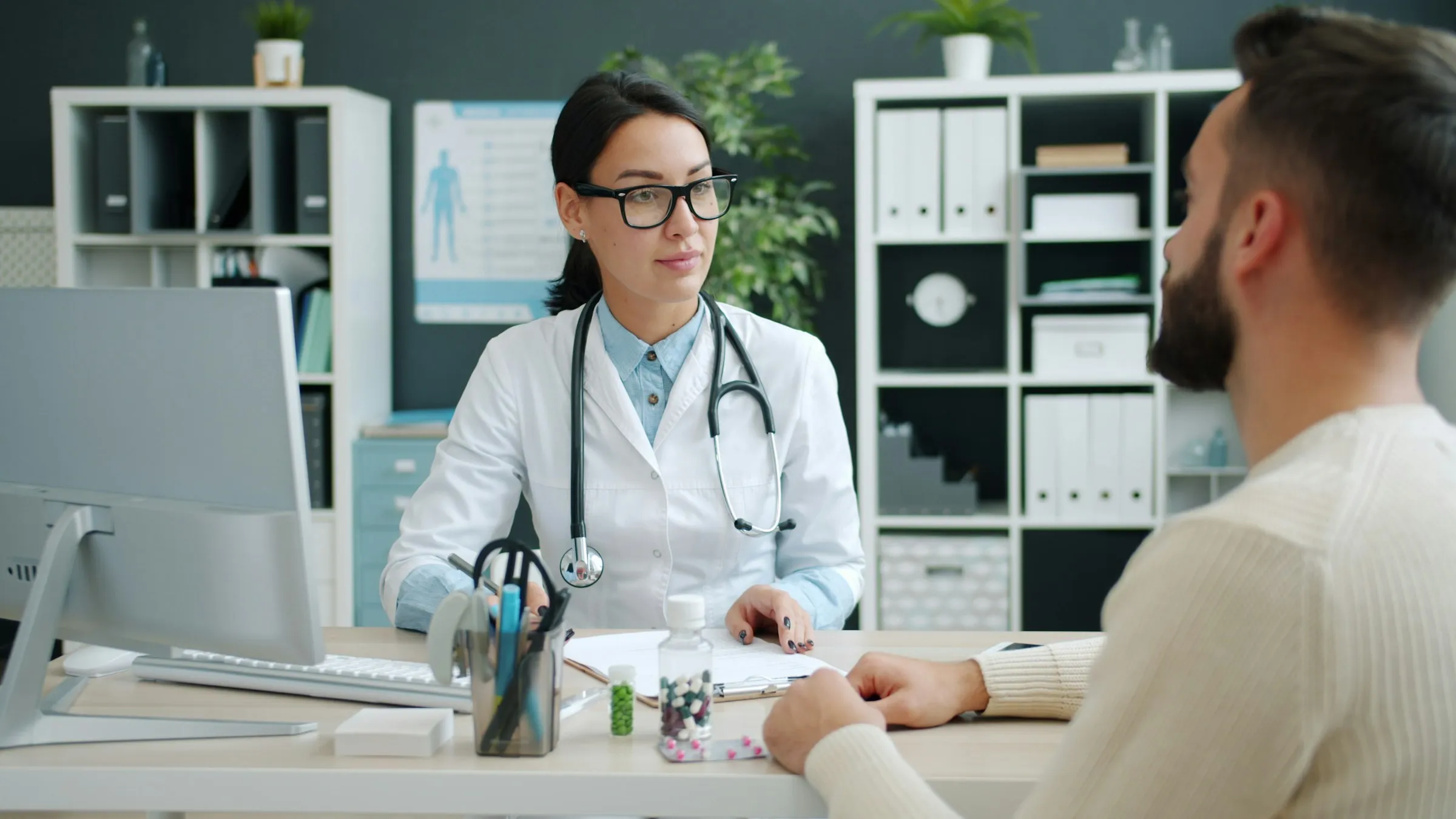 Doctor consulting a patient at her desk